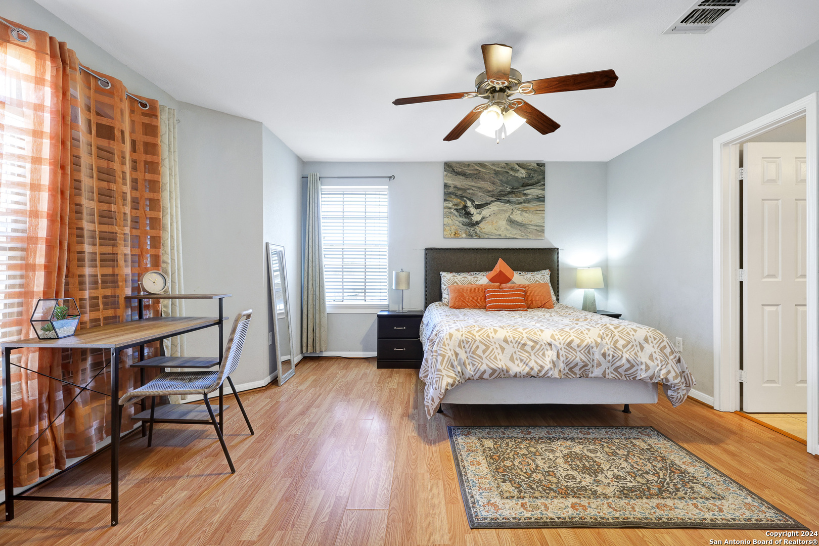7323 Snowden Road, Unit 3308 San Antonio, TX 78229 - Photo 14 of 26 a bedroom with a bed and wooden floor