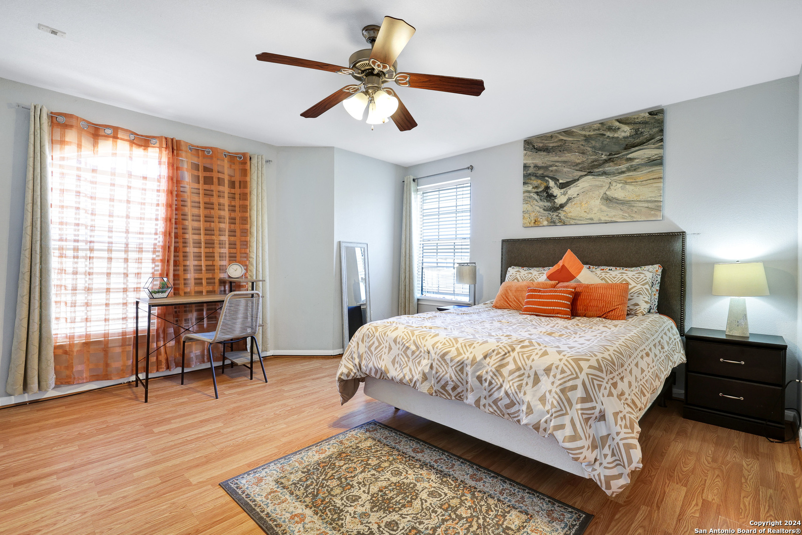 7323 Snowden Road, Unit 3308 San Antonio, TX 78229 - Photo 15 of 26 a bedroom with a bed a dresser and wooden floor
