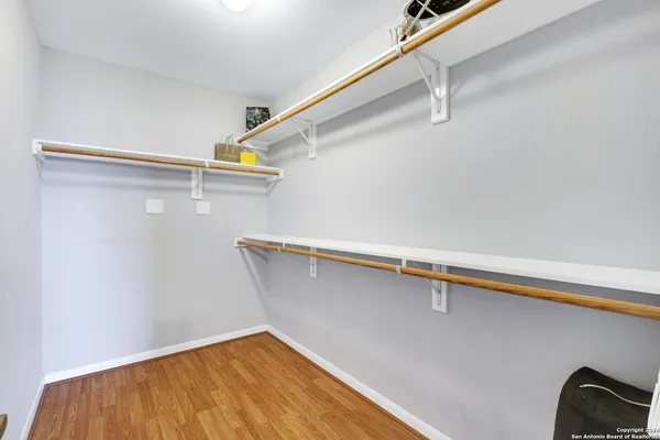 a bathroom with a granite countertop sink a toilet and mirror