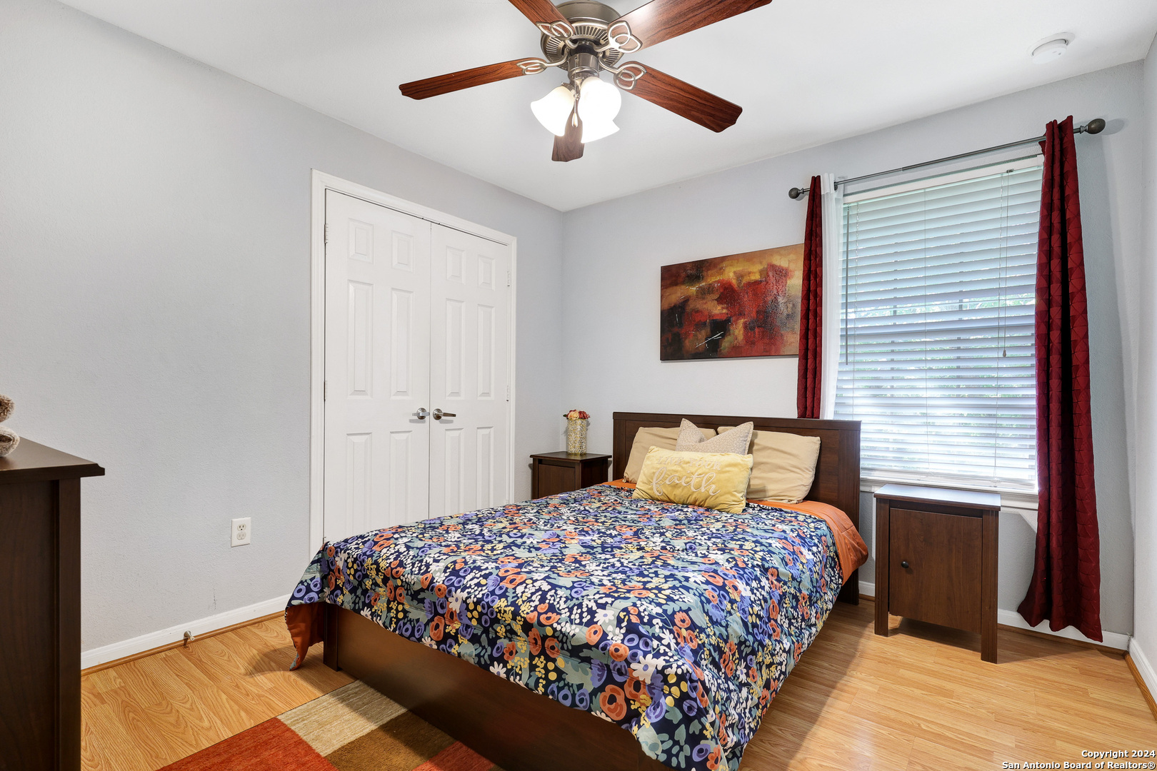 7323 Snowden Road, Unit 3308 San Antonio, TX 78229 - Photo 19 of 26 a bedroom with a bed and a chandelier