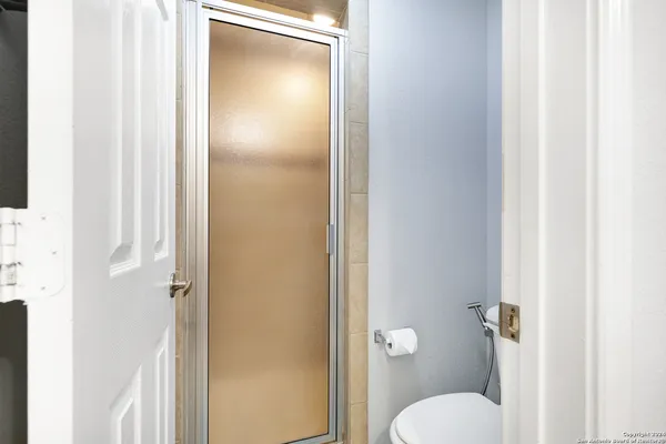 a front view of a house with balcony and garden