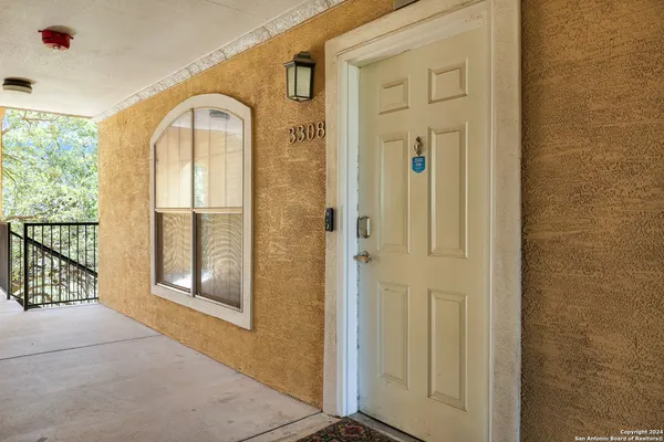 a living room with furniture a clock and a ceiling fan