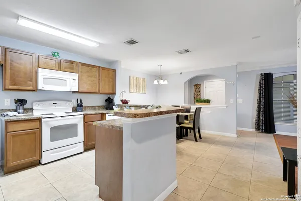 a kitchen with a sink stove top oven and cabinets