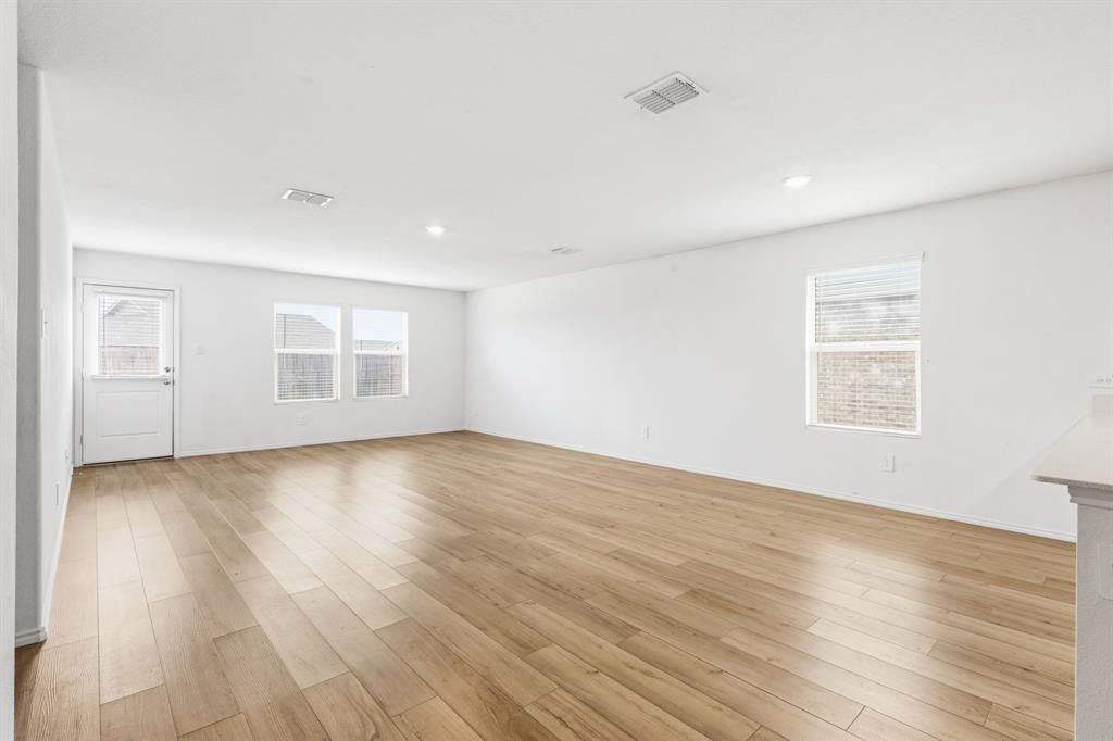 2604 Spring Time Drive Ennis, TX 75119 - Photo 11 of 21 an empty room with wooden floor and windows