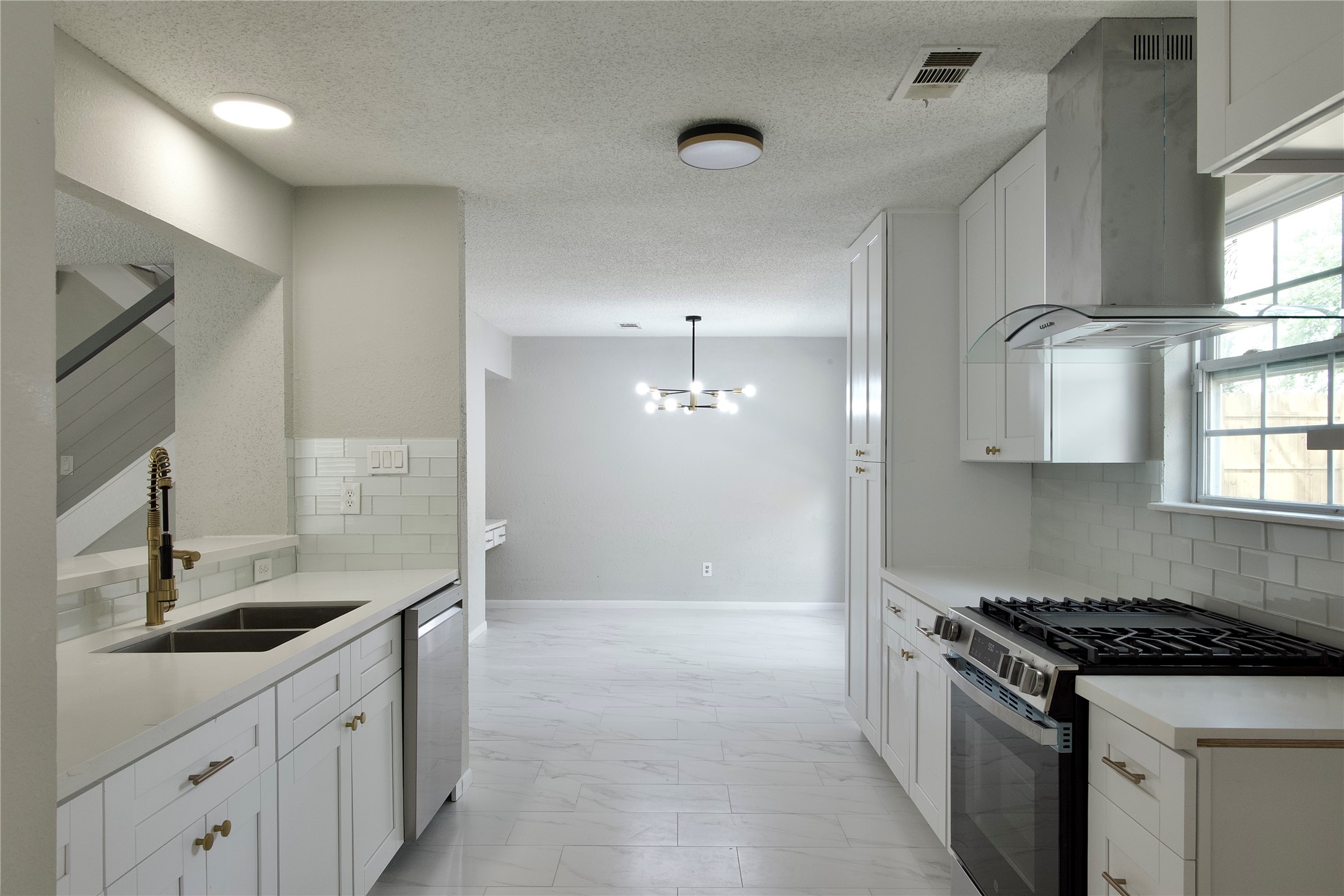 5111 Pinewilde Drive Houston, TX 77066 - Photo 16 of 37 a kitchen with granite countertop a sink stove and cabinets