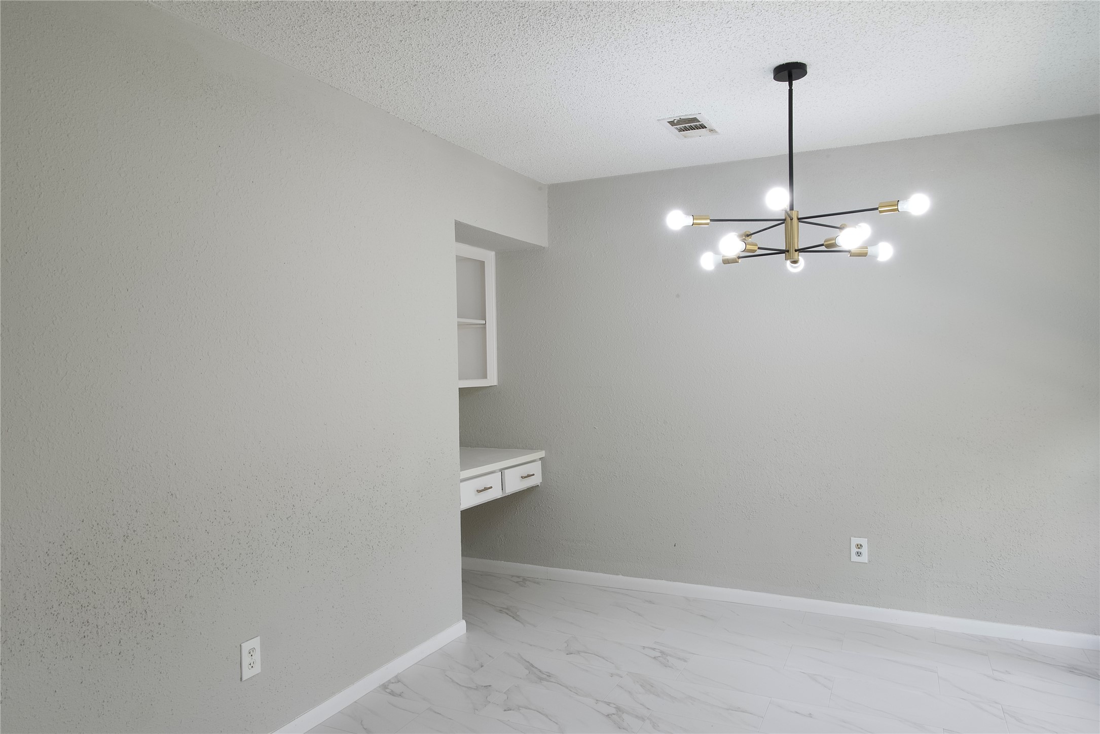 5111 Pinewilde Drive Houston, TX 77066 - Photo 19 of 37 a view of a room with a hanging light and kitchen