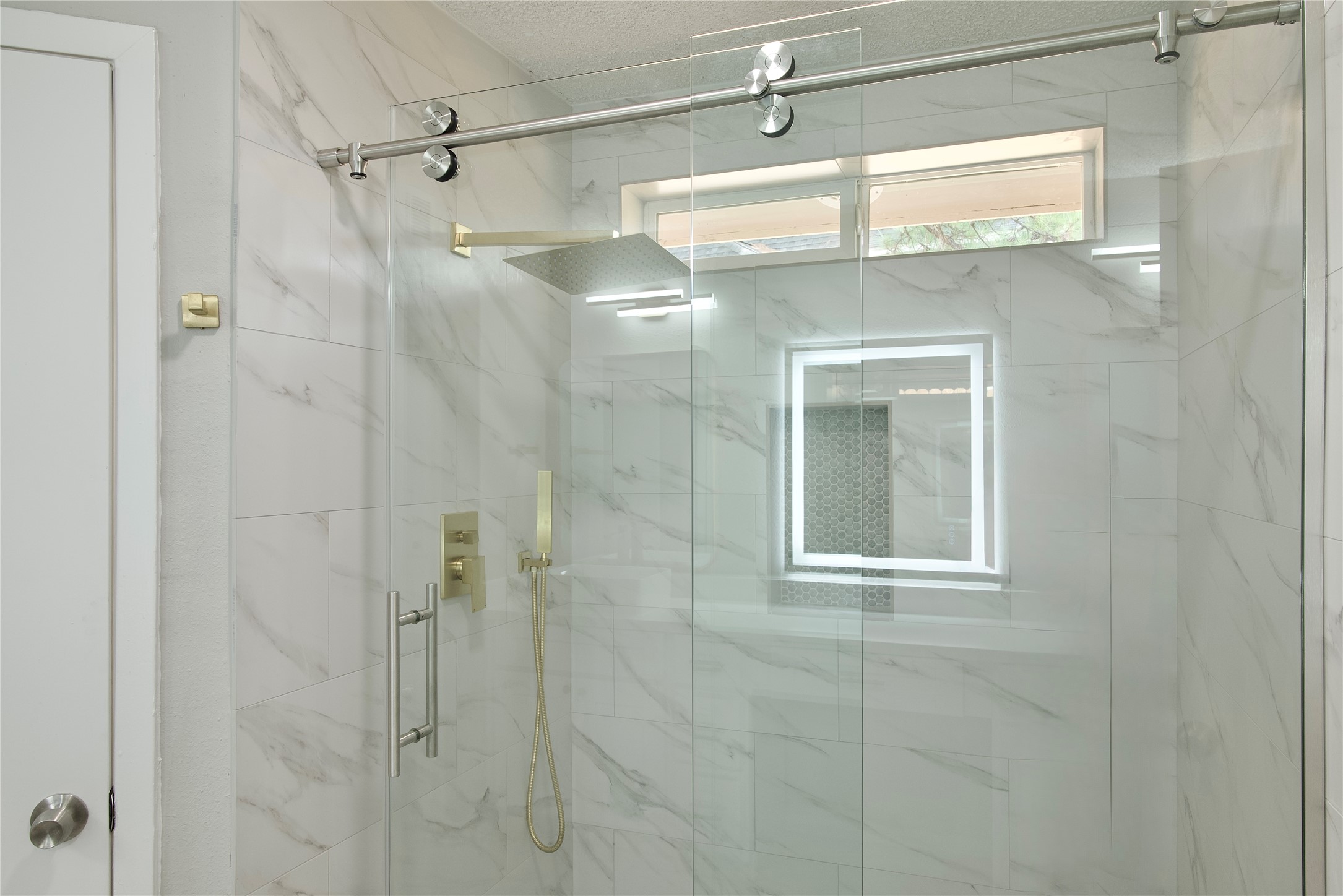 5111 Pinewilde Drive Houston, TX 77066 - Photo 25 of 37 a bathroom with a shower and a glass door