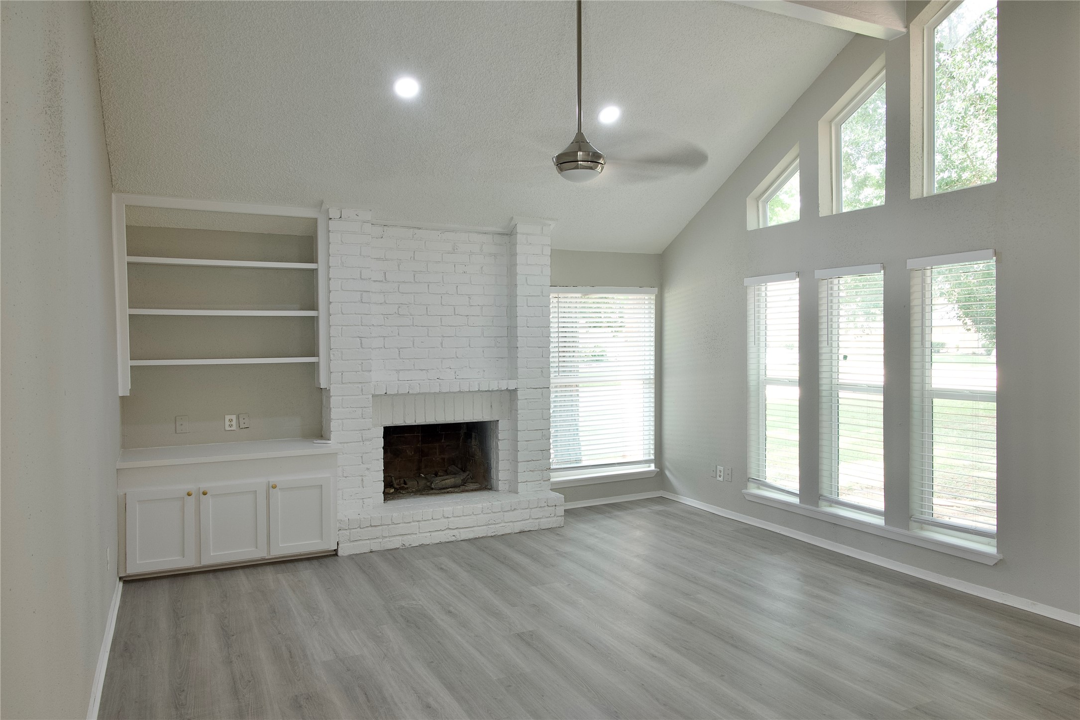 5111 Pinewilde Drive Houston, TX 77066 - Photo 8 of 37 a view of an empty room with a fireplace and a window