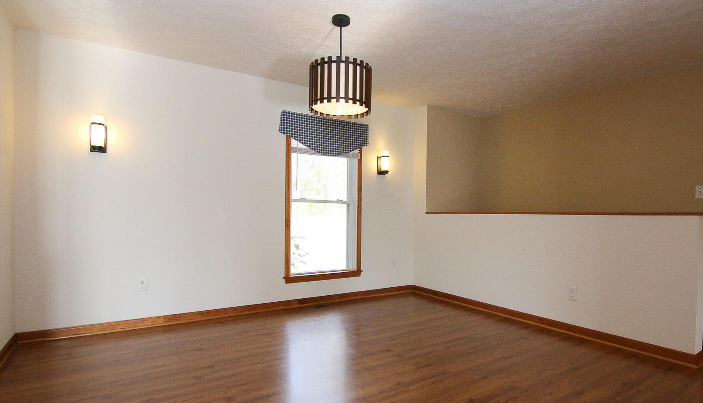 860 Beech Mountain Road Ferrum, VA 24088 - Photo 10 of 48 an empty room with wooden floor cabinet and windows