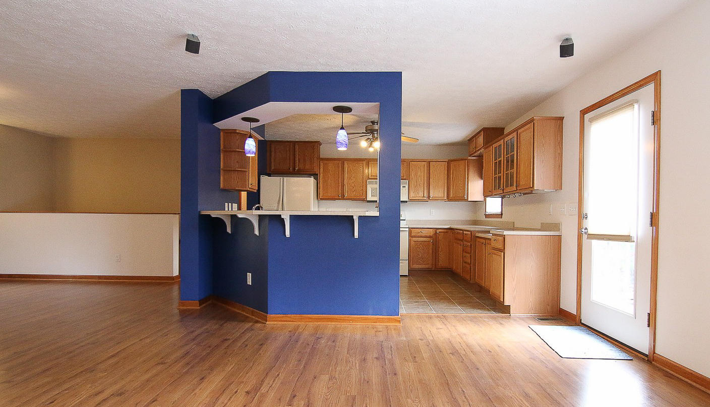 860 Beech Mountain Road Ferrum, VA 24088 - Photo 12 of 48 a view of a kitchen with a fridge and wooden floor