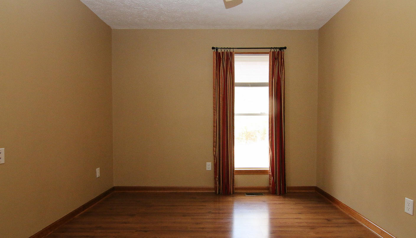 860 Beech Mountain Road Ferrum, VA 24088 - Photo 25 of 48 a view of an empty room with wooden floor and a window