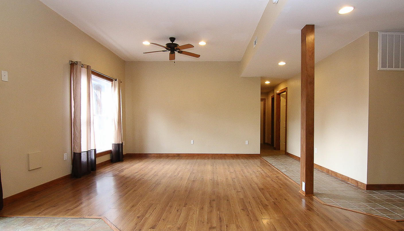 860 Beech Mountain Road Ferrum, VA 24088 - Photo 32 of 48 a view of an empty room with wooden floor and a window