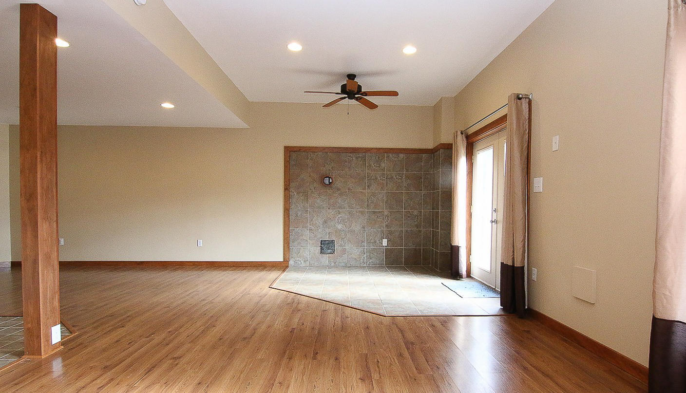 860 Beech Mountain Road Ferrum, VA 24088 - Photo 33 of 48 an empty room with wooden floor and windows
