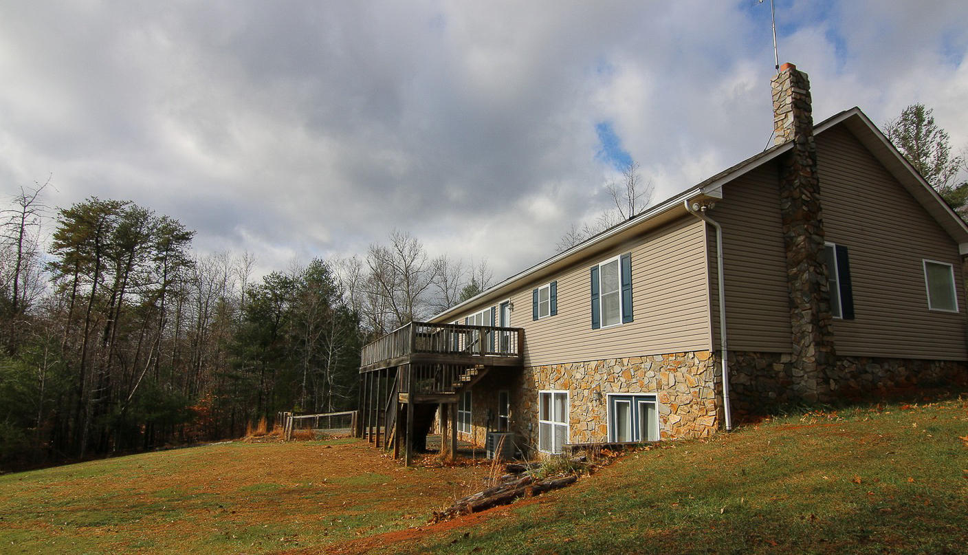 860 Beech Mountain Road Ferrum, VA 24088 - Photo 46 of 48 a view of house with yard and trees in the background