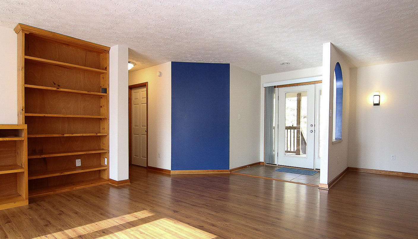 860 Beech Mountain Road Ferrum, VA 24088 - Photo 5 of 48 a view of an empty room with wooden floor and windows