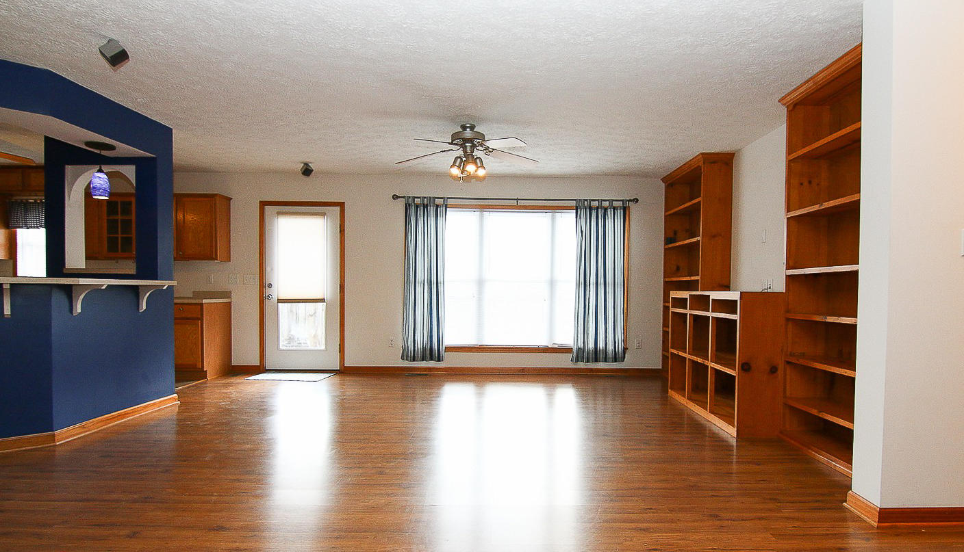 860 Beech Mountain Road Ferrum, VA 24088 - Photo 7 of 48 a view of an empty room with a window and wooden floor