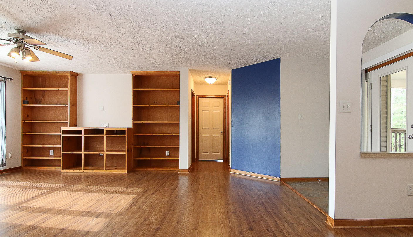 860 Beech Mountain Road Ferrum, VA 24088 - Photo 8 of 48 a view of an empty room with wooden floor and windows