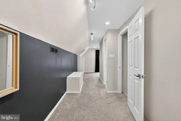 a view of a hallway with toilet and entryway