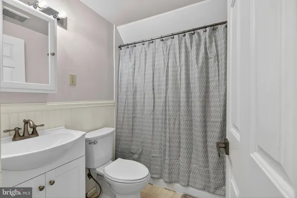 a white toilet sitting next to a bathroom sink