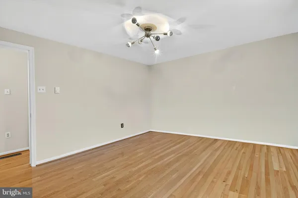 a view of a room with wooden floor