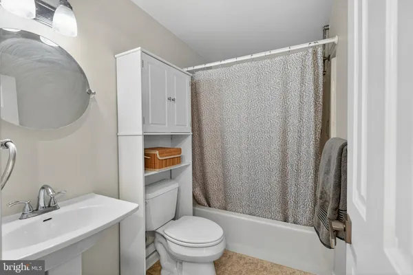 a bathroom with a sink toilet and mirror
