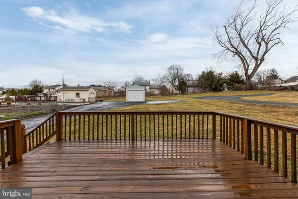 a balcony with wooden floor and city view