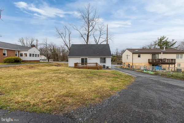a front view of a house with a garden and tree