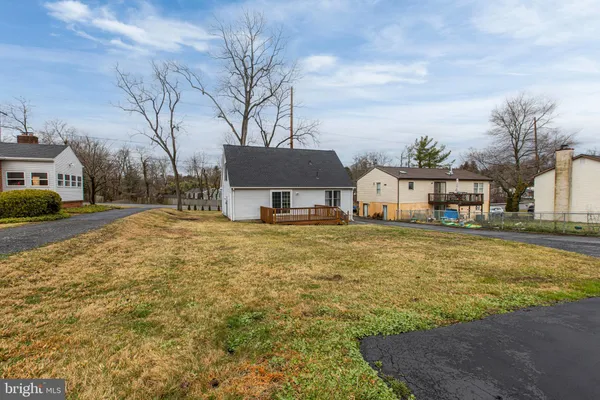 a house view with swimming pool in front of it