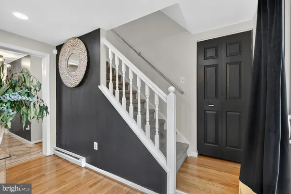 a view of a hallway with entryway wooden floor and front door