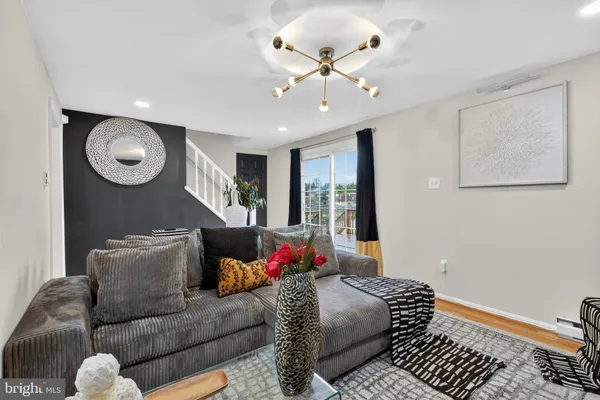 a living room with furniture and a chandelier
