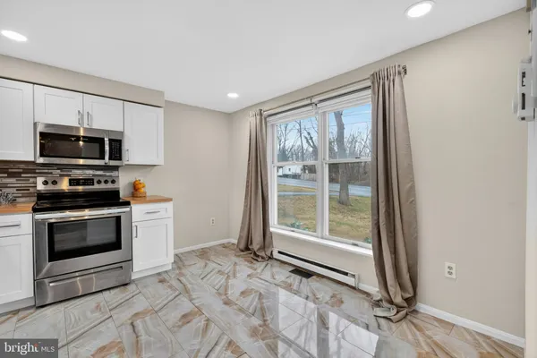 a kitchen with a stove a sink and a microwave