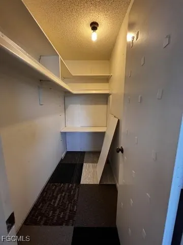 a swimming pool view with a seating space