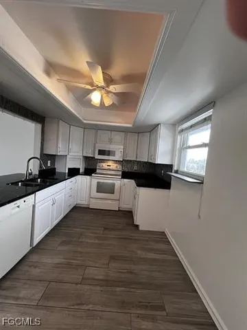 a kitchen with refrigerator and microwave