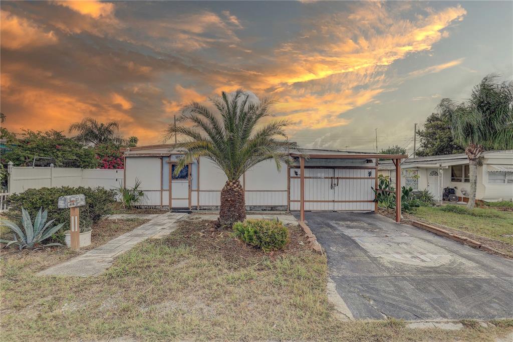 1852 Hoyle Drive Holiday, FL 34691 - Photo 1 of 1 a front view of a house with a yard and garage