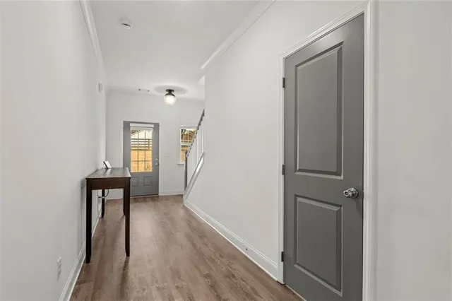 a kitchen with a dining table chairs stainless steel appliances and cabinets