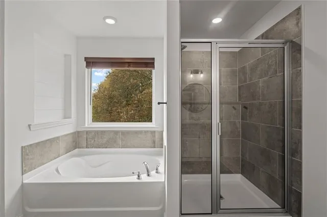 a bathroom with a sink a toilet a mirror and shower