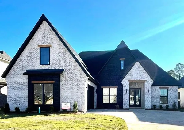 a front view of a house with yard