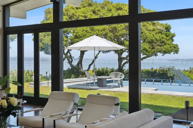 a dining room with furniture a chandelier and wooden floor