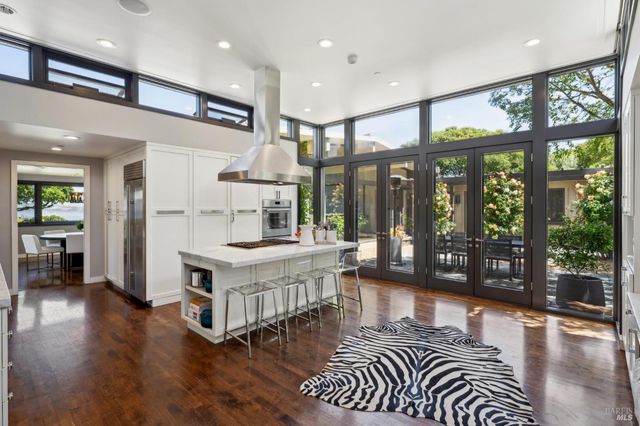 a view of a dining room with furniture large windows and wooden floor