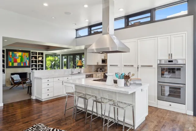 a living room with furniture fireplace and a large window