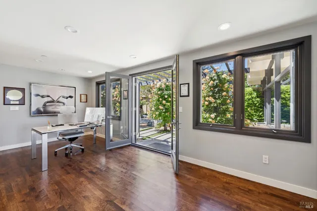 a bedroom with a bed couch and wooden floor