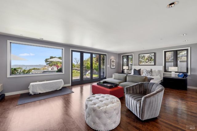 a spacious bedroom with a bed a couch and a large window