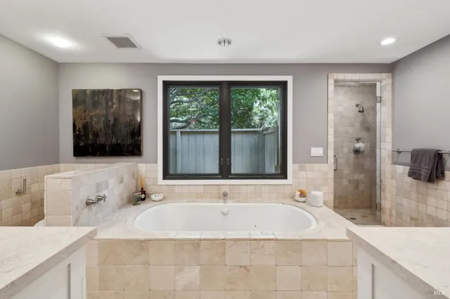 a large white kitchen with lots of counter space a sink and appliances
