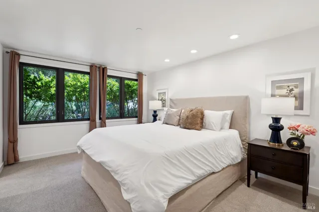 a bedroom with a large bed and a large mirror