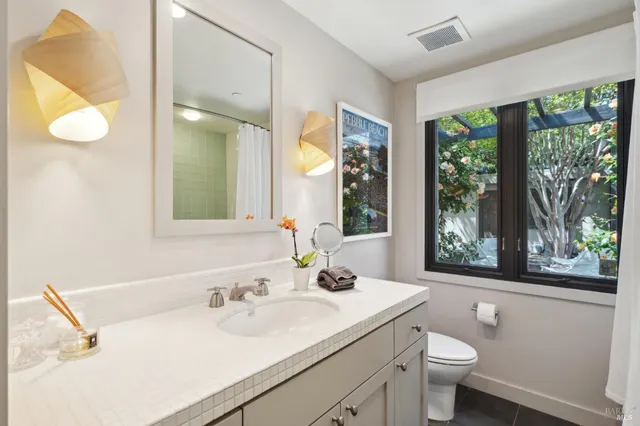 a bedroom with a large bed couch and a large window