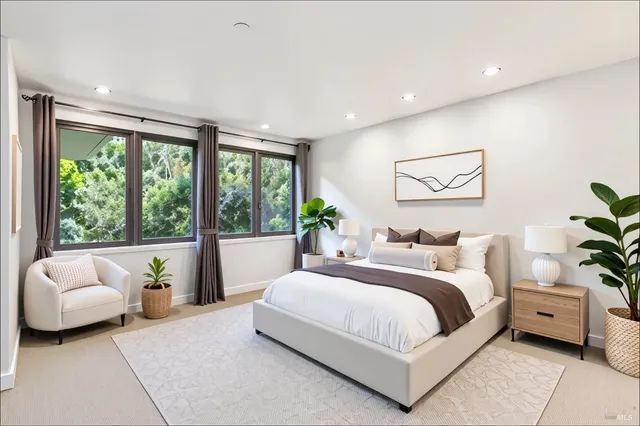 a large bedroom with a bed and glass window