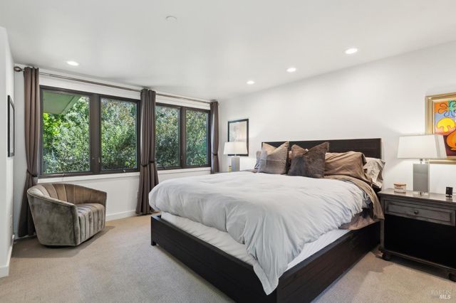 a kitchen with a sink a stove and white cabinets