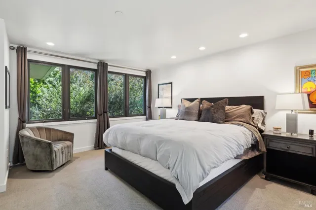 a kitchen with a sink a stove and white cabinets