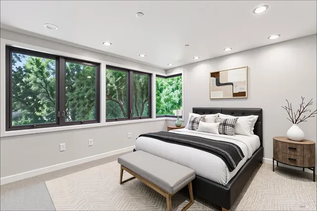 a bedroom with a bed and a large window