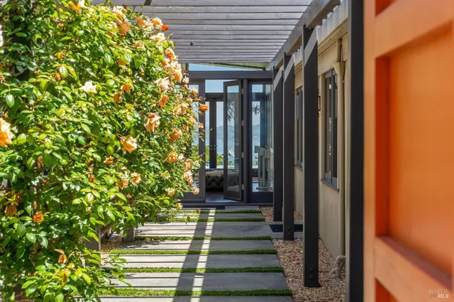 a view of a patio with table and chairs and potted plants